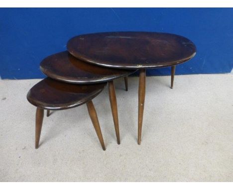 A nest of three dark oak Ercol occasional tables.