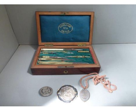 A rosewood boxed Excelsior No.5 Series geometry set presented to Robert Bennell 1895-1896 and three religious medallions. 