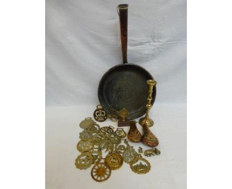 A Victorian copper frying pan, an assortment of horse brasses, two hunting powder/shot flasks and a Victorian brass candlesti
