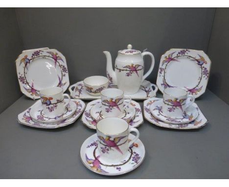 A decorative four setting coffee set comprising coffee cans, side plates, saucers, a coffee pot and a sandwich tray. 