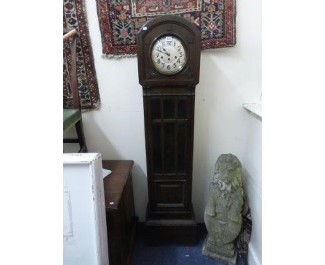 A 1930s/1940s oak longcase clock. 