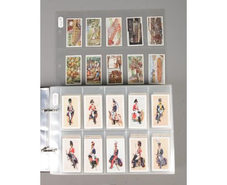 A folder containing a large collection of cigarette and tea cards, in 14 complete sets. John Player & Sons Products of the Wo