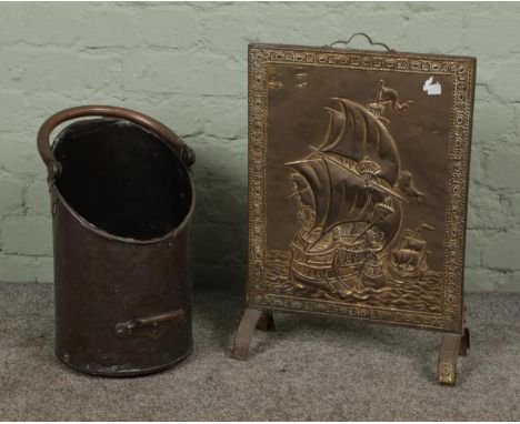 A copper coal scuttle with swing handle together with a fire screen depicting a sailing ship.