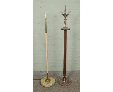 A standard lamp with onyx base and brass fluted column leading to a leather clad stem with another example with wooden stem a