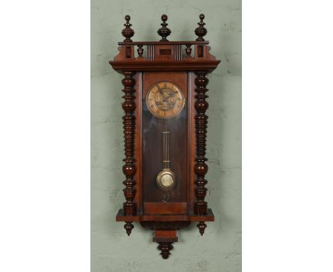 A Vienna Style wall clock, with bobbin detailing. The German movement featuring Roman Numeral markers, chiming on a coiled go