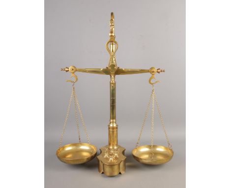 A set of brass balance scales with inset weights