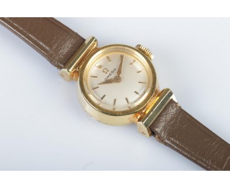 A ladies gold plated Omega manual cocktail watch, featuring baton markers to the dial. On brown Omega strap.
