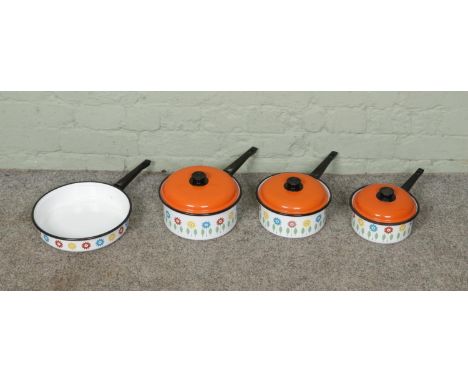 A set of four vintage 1960s enamel saucepans and pot with orange lids, with floral decoration.  All in good condition. Diamet