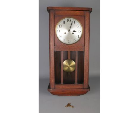 An antique "Stockall London" chiming wall clock, with Arabic numeral  dial and comes with pendulum and key.  Running, size W3