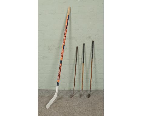 A vintage autographed Montreal ice hockey stick accompanied by three hickory golf clubs. The hockey stick features signatures