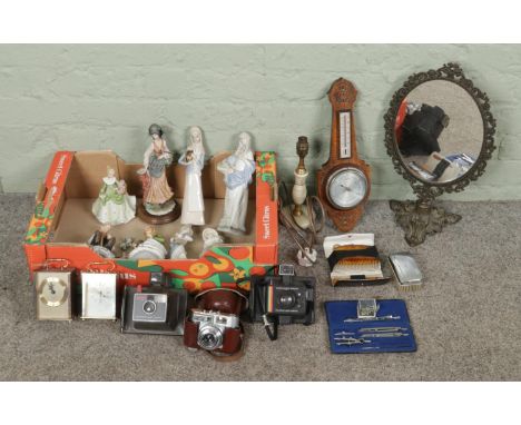 A box of vintage miscellaneous items, including clocks, cameras, ceramic figurines, brass swivel vanity mirror, barometer and