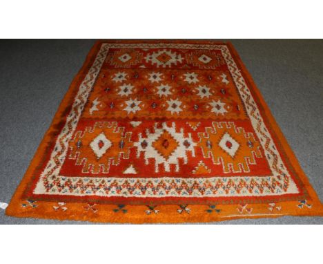 Berber Carpet Morocco, circa 1960 The compartmentalised field of hooked and stellar devices enclosed by ivory borders, 300cm 