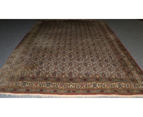 Ghom Carpet Central Iran, circa 1950 The ivory field with a lattice of botehs enclosed by angular vine borders, 367cm by 270c