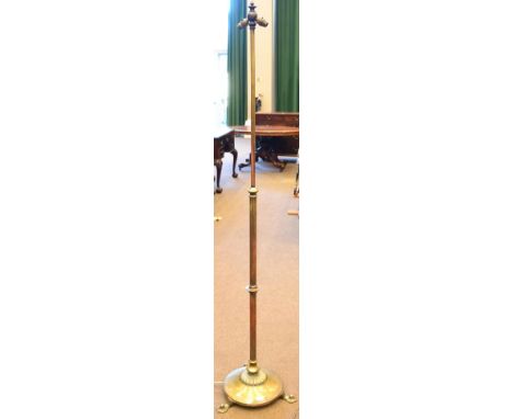 A Brass Arts & Crafts Style Adjustable Standard Lamp, fitted for electricity with two bayonet cap fittings, on a fixed suppor