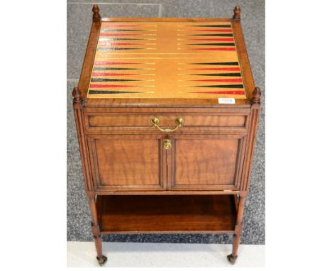 A Victorian Walnut Gaming Trolley, late 19th century, the leather top above a long frieze door with hinged cupboard door belo