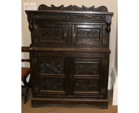 A Joined Oak Press Cupboard, initialled ASE and bearing date 1683, with carved frieze above inverted turned finials and geome