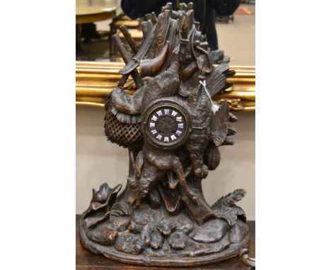 A Carved Black Forest Striking Mantel Clock, circa 1880, carved case depicting a hunting theme, floral decorated base, cast d