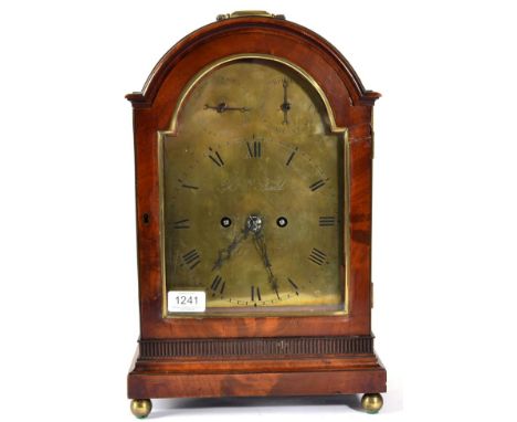 A Mahogany Table Clock, arched pediment with a carrying handle, brass ball feet, 7-1/4-inch one piece arched brass dial with 