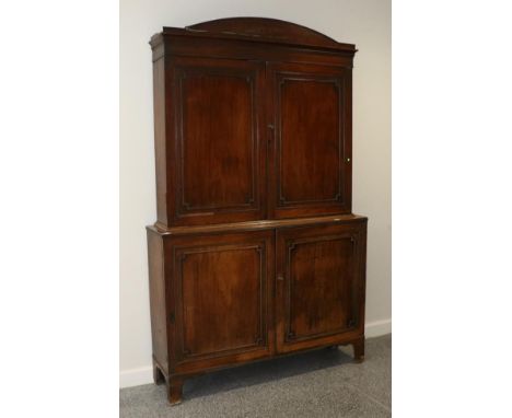 A Regency Mahogany Bookcase Cabinet, circa 1820, the architectural pediment above moulded cupboard doors enclosing three adju