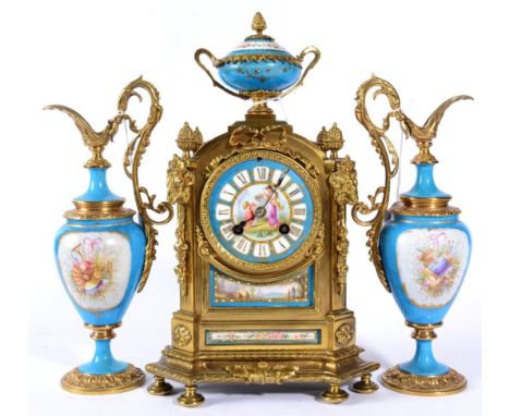 A Gilt Metal and Porcelain Mounted Striking Mantel Clock with Garniture, circa 1890, surmounted with an urn finial, rams head