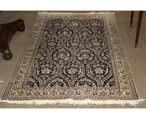 Nain Rug Central Iran, circa 1970 The indigo oval lattice floral field enclosed by ivory borders, 168cm by 110cm