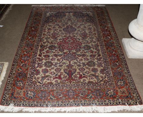 Isfahan Rug Central Iran, circa 1960 The ivory ground centred by a raspberry medallion framed by spandrels and madder borders