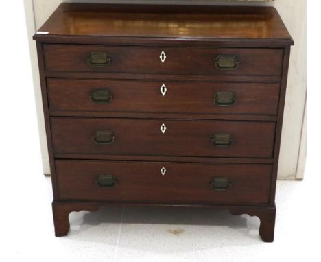 A George III Mahogany Straight Front Chest of Drawers, circa 1800, with moulded top above four graduated drawers with ivory e