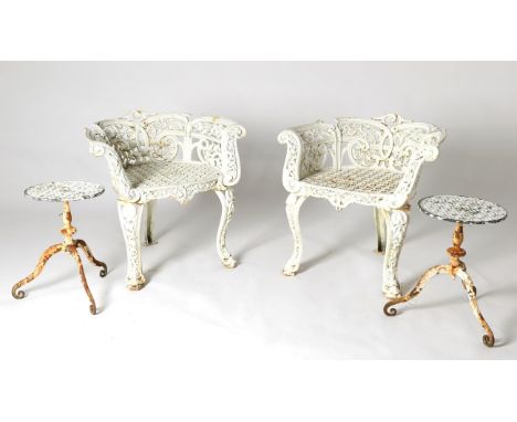 A Pair of Late Victorian White Painted Cast Iron Garden Armchairs, circa 1900, the scrolled arm supports above a geometric pa