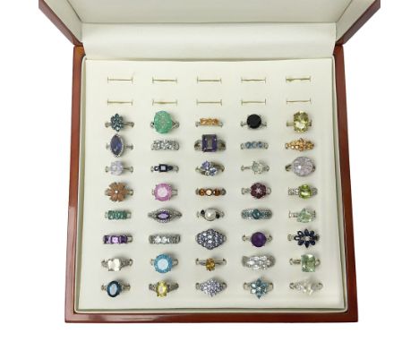 Forty silver stone-set rings including topaz, amethyst, tanzanite etc, all tested and stamped 925, housed in a presentation r