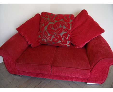 Nearly new two seat sofa with loose cushions on raised chrome effect supports (width 165cm)