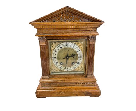 Oak cased bracket clock with brass and silvered dial.