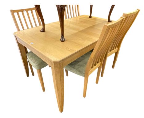 Ercol light oak extending dining table with integral leaf, 74cm by 85.5cm by 139.5cm excluding leaf together with a set of fo