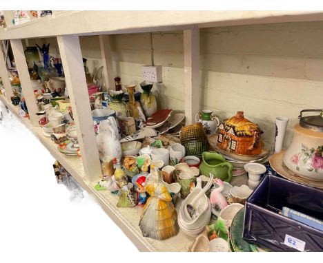 Full shelf of glass and china including Ringtons caddies, ornaments, figurines, vases, etc.