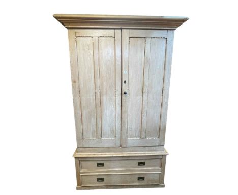 Victorian pine wardrobe having two doors enclosing five sliding trays above a base of two long drawers, 226cm by 141cm by 65c