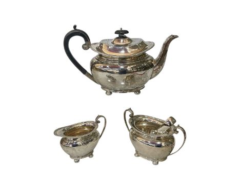 Silver three piece tea service of oblong form on bun feet, Sheffield 1919.