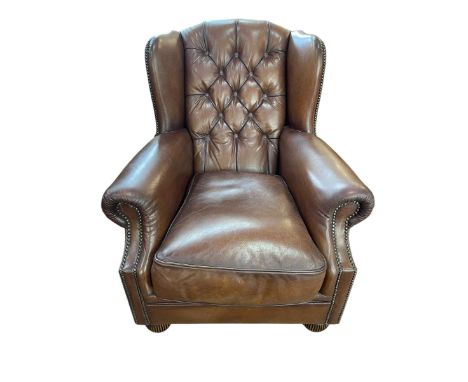 Tetrad Oskar brown leather button backed and brass studded Chesterfield armchair, 95cm by 85cm by 95cm.