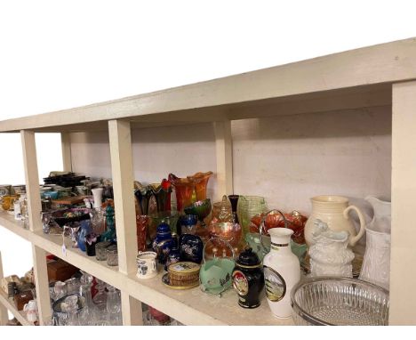 Full shelf of glass and china including Carnival Glass, relief moulded jugs, Wallace & Gromit ornaments, Dunoon mugs, etc.
