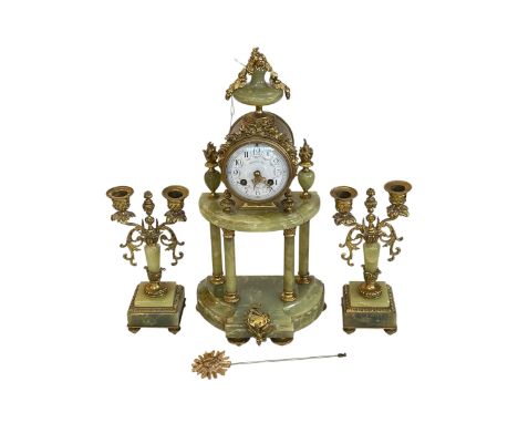 Ornate three piece gilt metal and onyx clock garniture with enamel dial.
