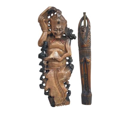 Carved figure holder with pipe and soapstone carving (2).