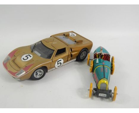 A Universal Hobbies 18th scale model Ford GT40, and a clockwork tinplate racing car, (2).