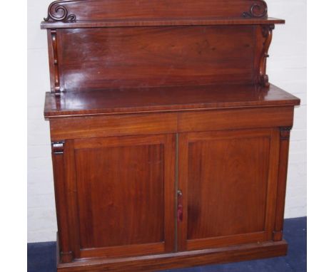 A William IV mahogany chiffonier, the single shelf back raised on scrolling supports, over a pair of cushion drawers over a c