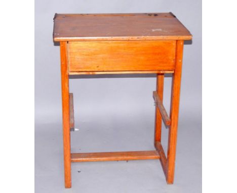 An old school desk, with pen and inkwell recess, lift up top, raised on rectangular straight legs united by stretchers, 62cm 