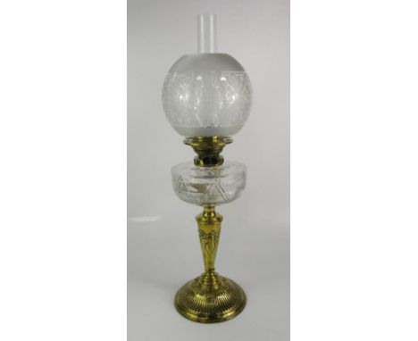 A Palmer & Co duplex brass and cut glass oil lamp, the stem embossed with flowers, with etched glass shade, 66cm high.