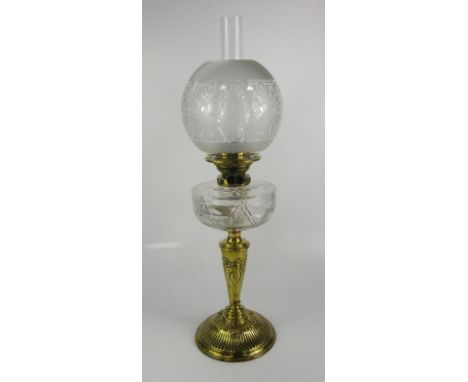 A Palmer & Co duplex brass and cut glass oil lamp, the stem embossed with flowers, with etched glass shade, 66cm high.