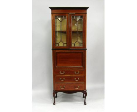 An Edwardian mahogany and boxwood line inlaid secretaire cabinet, two glazed doors enclosing a shelf over a drop flap enclosi