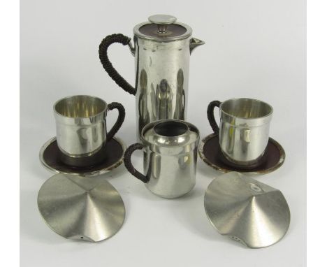 A pewter part coffee set designed by Hayley Lewis for Wentworth Pewter, comprising coffee pot, cream jug, two cups and saucer