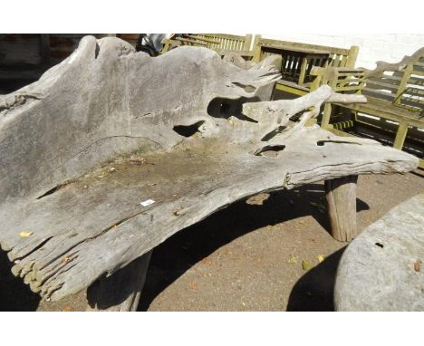 A two seater driftwood bench.