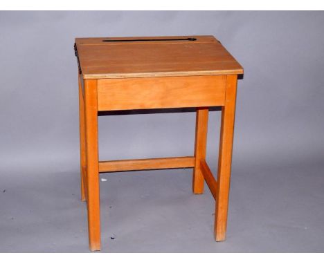 An old school desk, with pen and inkwell recess, lift up top, raised on rectangular straight legs united by stretchers, 56cm 