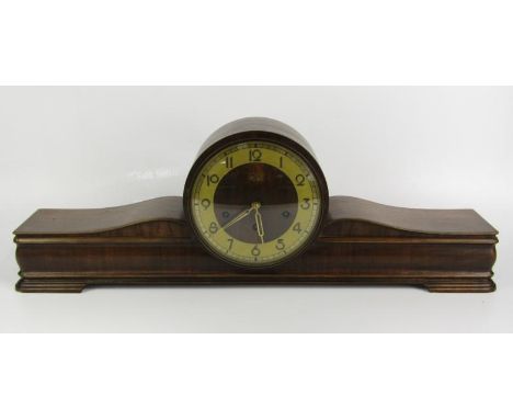 A Kienzle walnut cased Art Deco mantel clock, wooden dial with brass chapter ring bearing Arabic numerals, eight day movement