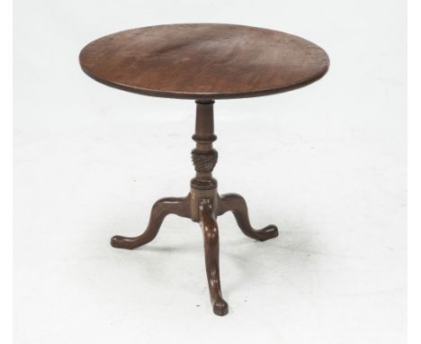 A GEORGE III OAK TILT TOP TRIPOD TABLE, the circular top above a turned baluster standard raised on down swept legs terminati